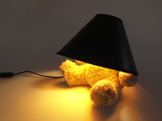 The Teddy Bear LED Lamp from Suck UK is a table lamp with a lamp shade on top of a teddy bear, concealing its head. A perfect lamp for creating a very warm and soft light.