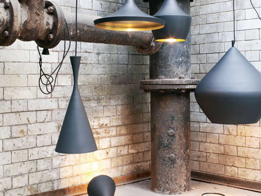 The Beat Light pendant lamps by Tom Dixon showcase elegant design from London. The shade is painted black and the interior is brass coloured. They are available in three different forms.