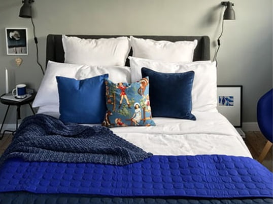 Blue room design with the Baby Dot Quilt by HAY. Blogger BritDecor uses different textures and tones to create depth and energy.