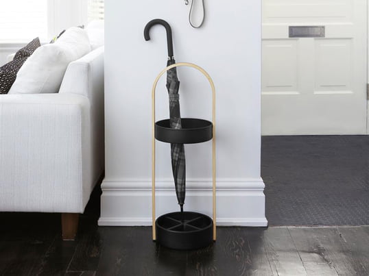 The Hub umbrella stand by Umbra in the ambience view: Stick umbrellas can be conveniently placed in the Hub umbrella stand, while small pocket umbrellas can be attached to the Hub wall hook to drip off.