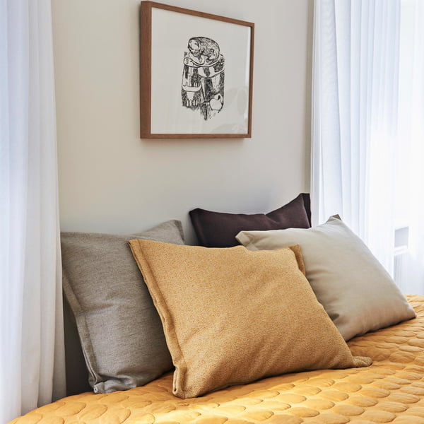 Plica Sprinkle pillow by Hay arranged on the bed