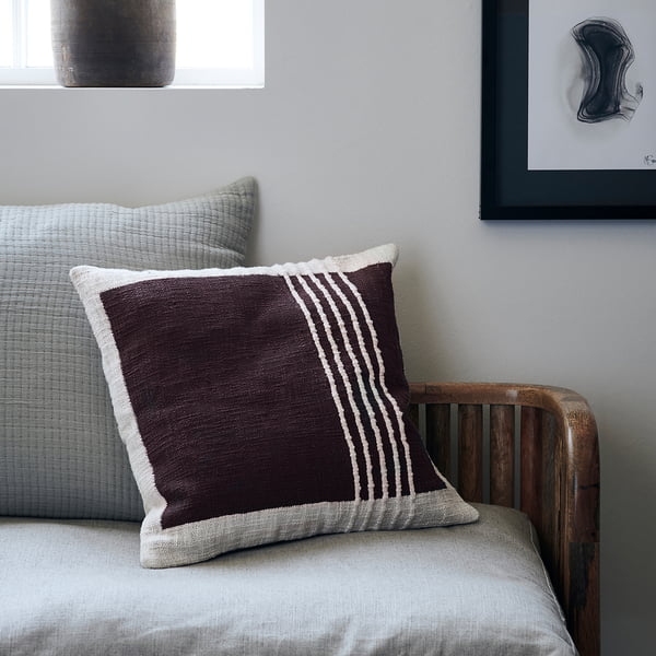 The Yarn pillowcase, brown by House Doctor as a decorative pillow on the couch