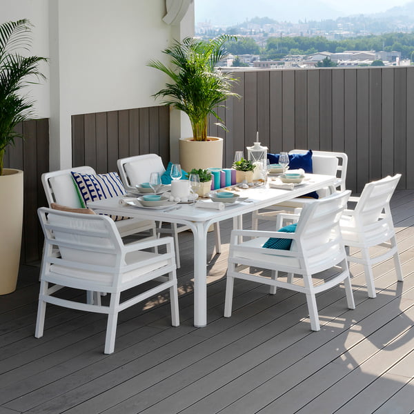 The white Alloro 210 extending table from Nardi is stable and stylish on the wooden terrace.